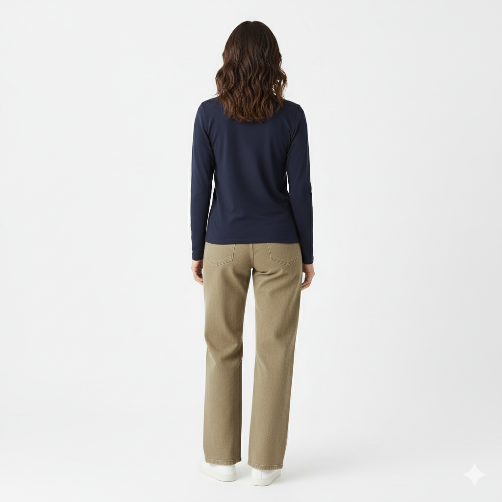 Person wearing a navy long-sleeve shirt and beige pants on a white background