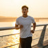 Man running on a bridge during sunset