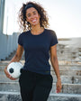 Woman holding a soccer ball outdoors on steps
