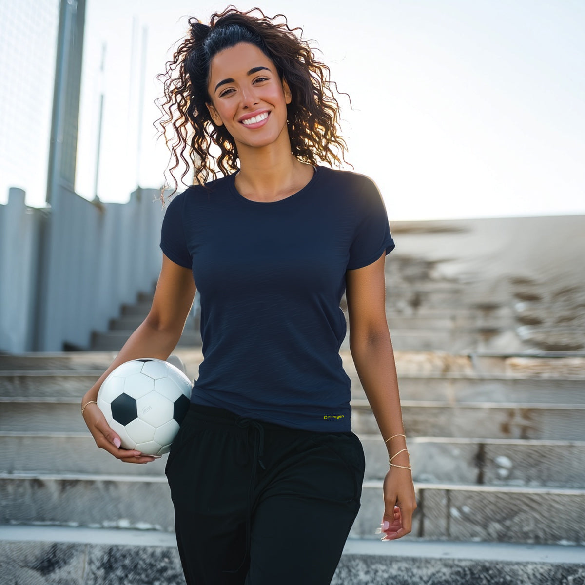 Woman holding a soccer ball outdoors on steps