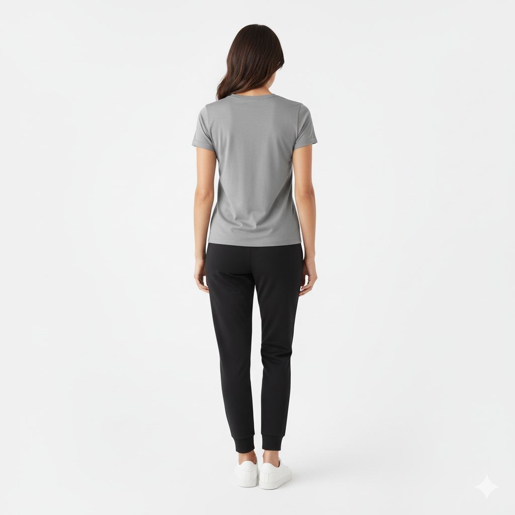 Woman wearing a gray t-shirt and black pants on a white background