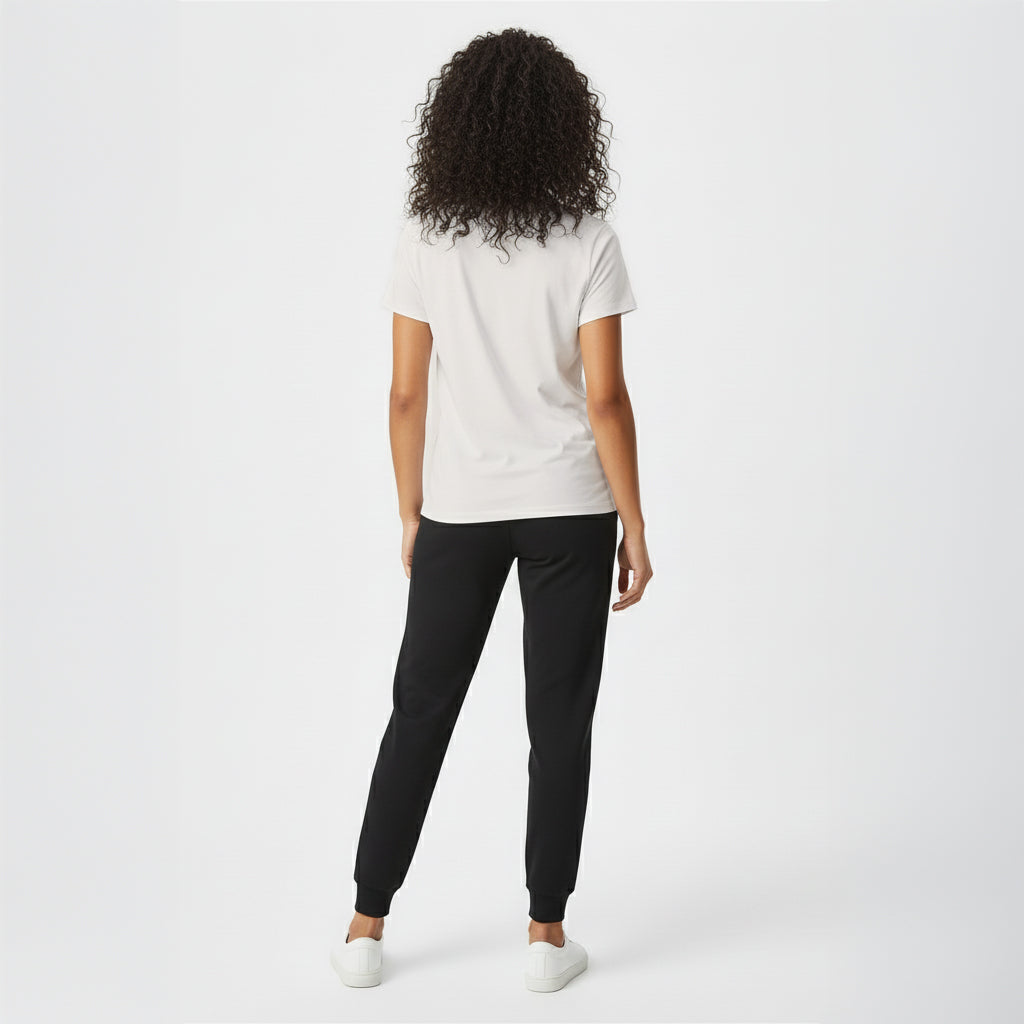Person wearing a white t-shirt and black pants on a white background
