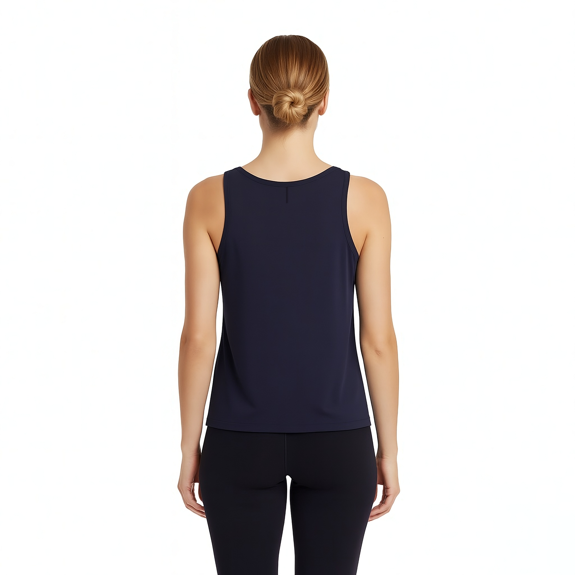 Woman wearing a navy sleeveless top and black leggings on a white background