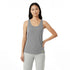 Woman wearing a gray tank top with a brand logo on a white background